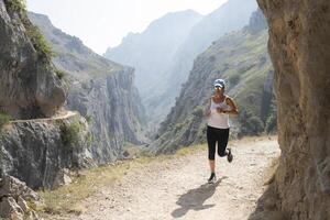 Woman running down path with sunglasses on the route of the cares photo