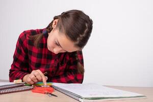 girl studying concentrated using calculator on study table photo