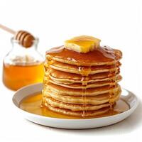 AI generated Tall stack of thick pancakes with honey isolated photo