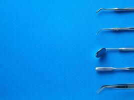 Dental tools on blue background photo