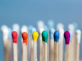 The concept of diversity and inclusiveness. Multicolored matches. photo