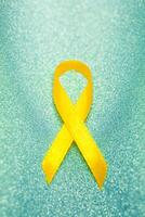 Gold ribbon for children as a symbol of childhood cancer awareness. World Cancer Day photo