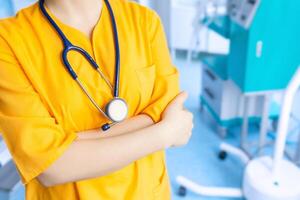 Concept doctor's background in yellow uniform in operating room photo