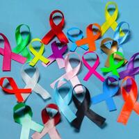 World Cancer Day. Colorful ribbons, cancer awareness, blue background. International Agency for Research on Cancer photo