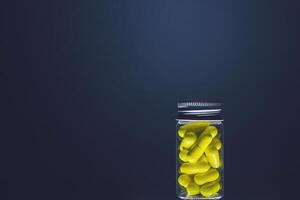 Yellow capsules in a transparent glass bottle of medium size, isolated on a dark background. Natural supplements for health. Studio lighting photo