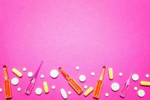 pharmaceutical medical pink background. Top view of the pills, ampoules, pills. Place for text photo