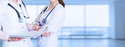 Impersonal portrait of a female doctor in front of a bright background photo