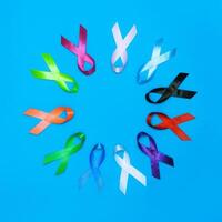 World cancer day February 4 background. Colorful ribbons, cancer awareness. blue surface from above photo