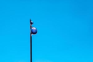 Blue science background. Drops on the end of a medical needle close up photo