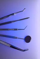 Dental tools on color background photo