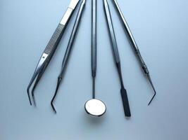 Dental tools on silver color background photo