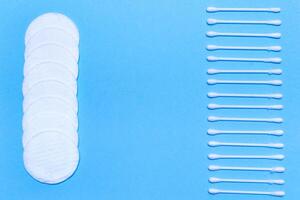 Cotton sticks and pads on a blue background, space for text photo