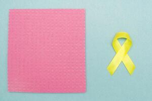 Golden ribbon for children as a symbol of childhood cancer awareness. World Cancer Day. photo