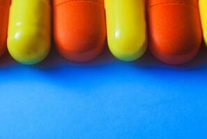 macro colourful pills on white selective focus. tablet on a blue background. A photo close up