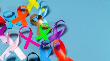 World Cancer Day. Colorful ribbons, cancer awareness, blue background. International Agency for Research on Cancer photo