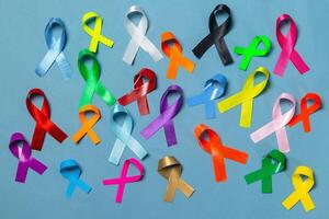 World Cancer Day. Colorful ribbons, cancer awareness, blue background. International Agency for Research on Cancer photo