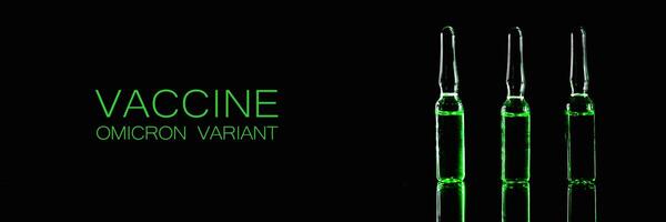 Pharmaceutical drugs banner. ampoules with green contents on a black background photo