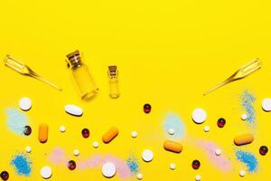 Yellow pharmaceutical medical background. Multicolored pills top view. childhood diseases. place for text. Copy space photo