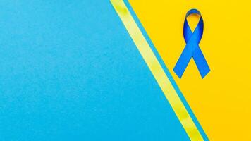 Dark blue ribbon awareness for aids day concept. yellow-blue background photo