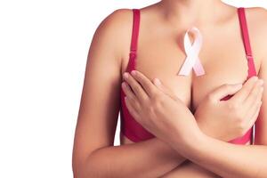 healthcare and medicine concept - woman with pink breast cancer awareness ribbon photo