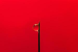 stop aids. No drugs. needle on a red background. Needle with a drop of contaminated blood at the end photo