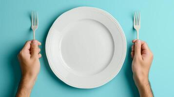AI generated man putting empty plate with fork and spoon on blue table photo