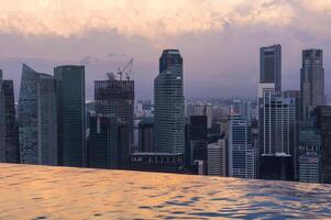 Singapore, Singapore, 2014, Downtown central financial district at sunrise viewed from the Infinity pool of the Marina Bay Sands , Singapore photo