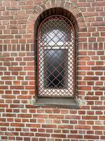 barred window in brick wall photo