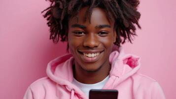 AI Generated An African American male model wearing a pink hoodie holding a cellphone using mobile apps on his cellphone while texting on his smartphone. The image is isolated on a dark purple photo