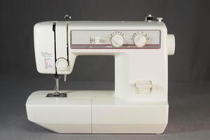 an old sewing machine sitting on a grey background photo