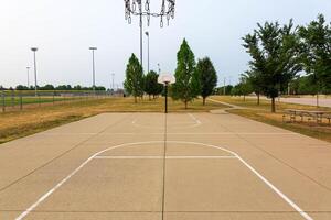 two open basketball courts on a smoky sky morning photo