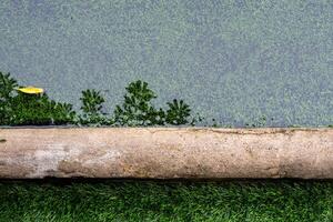 el reflexión de árbol en el inundación agua superficie en el artificial césped fútbol americano campo foto