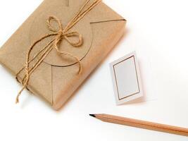 Gift box wrapped in kraft paper and rustic hemp as natural rustic style photo