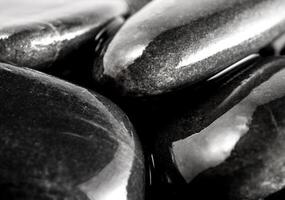 Round black stone on ground beside the waterfall photo