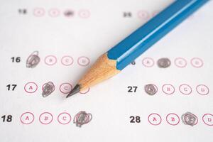 Answer sheets with pencil drawing fill to select choice, education concept. photo