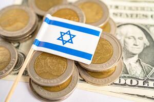 Stack of coins with Israel flag and US dollar banknotes. photo