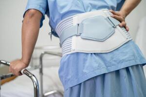 Asian lady patient use walker in hospital to support walking. photo