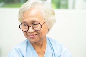 Asian senior woman wearing eyeglasses or vision glasses at home care service. photo