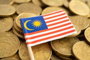 Malaysia flag on coins money, finance and accounting, banking concept. photo