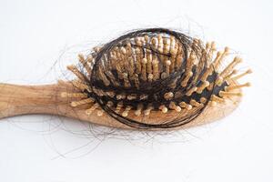 Hair loss fall with comb bush serious problem health, beauty and cosmetic concept. photo