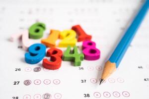 Math number and pencil on answer sheet paper, Education study testing learning teach concept. photo
