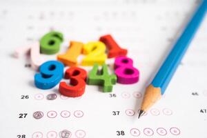 Math number and pencil on answer sheet paper, Education study testing learning teach concept. photo