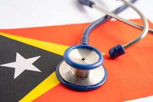 Stethoscope on East Timor flag background, Business and finance concept. photo