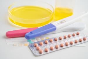análisis de orina, el embarazo prueba y orina taza con reactivo tira ph papel prueba en laboratorio, anticoncepción salud y medicamento. foto