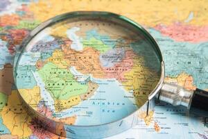 Bangkok, Thailand  January 20, 2022 Africa, Magnifying glass close up with colorful world map, travel, geography, tourism and exploration concept. photo