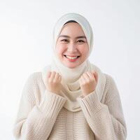 AI generated Radiant Asian Muslim woman in a cream sweater, expressing a joyful Eid Mubarak greeting gesture, isolated on a clean white background, capturing the essence of a religious lifestyle photo