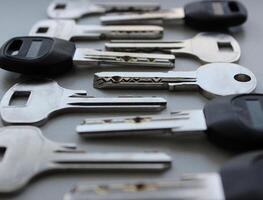 Laid out one by one modern lock keys angle view extreme closeup stock photo