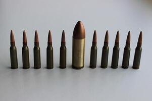 Conceptual photo on the theme of diversity with a large bullet in a row of identical smaller bullets