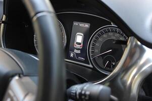 Angle view of the reverse gear indicator and parking sensors on the instrument panel of the car photo