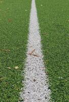 The receding distance is a straight white line on the artificial turf of the football field photo